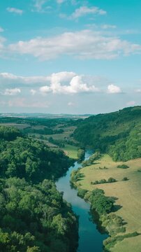 Time lapse of clouds passing over river in green countryside