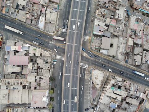 Aerial view of the intersection of Avenida Universitaria and Avenida Peru with dense urban buildings and traffic, San Martin de Porres, Provincia de Lima, Peru.