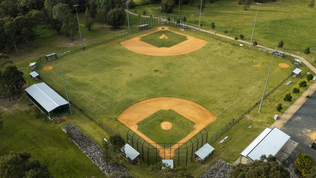 Aerial view of baseball diamonds at a sports complex with green grass, dirt infields, and surrounding trees in Beaumont Hills, New South Wales, Australia.