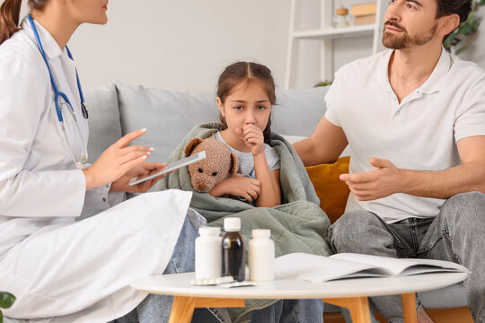 Female pediatrician working with sick girl and father at home