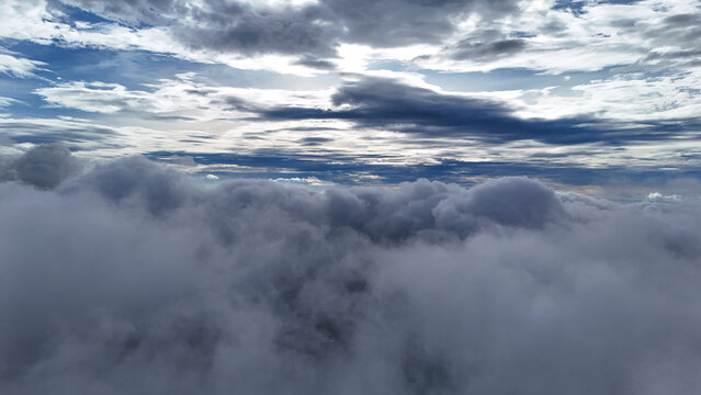 Aerial view of dense cloud formations filling the sky above the landscape in Sukabumi Regency, West Java, Indonesia.
