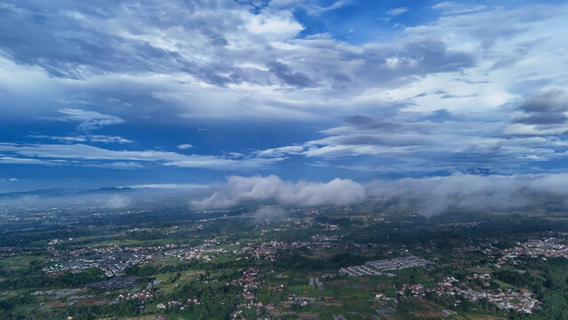 Aerial view of the lush landscape and scattered settlements in Sukabumi Regency, West Java, Indonesia.