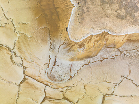 Aerial view of the dry, cracked earth and salt patterns of a lake bed in Pithara, Western Australia, Australia.