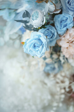 Light blue and pastel pink floral arrangement with decorative butterfly wings on light background