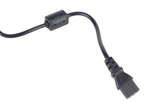 Black AC power cord with IEC C5 connector isolated from background. Laptop power supply cable with ferrite core filter close up. Electric power cable extension lead with cloverleaf connector isolated 