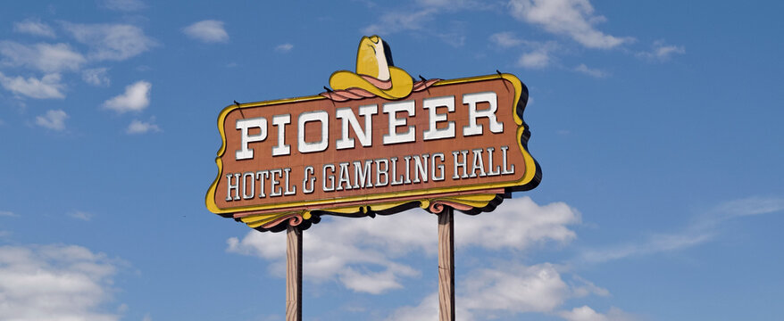 Sign for the Pioneer Hotel & Gambling Hall , a hotel and casino located on the banks of the Colorado River in Laughlin, Nevada