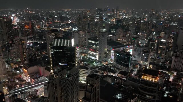 Breathtaking aerial views capture the shimmering urban landscape of Bangkok as night descends over the vibrant metropolis filled with illuminated towers. Thailand 26 april 2026