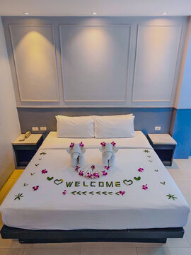 Hotel Room Decorated single double bedroom with nice white bed sheets purple decorative colours. the colour scheme is designed for Thailand and interior is m modern classical