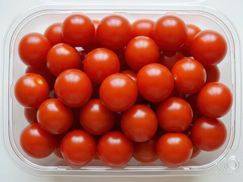 Fresh cherry tomatoes in plastic container