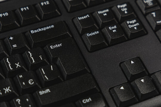 Black keyboard close-up in modern office workspace setting