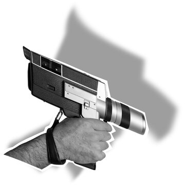 A hand grips a camera that resembles a gun. The camera has a metallic body and lens. It is on a transparent background, emphasizing its unique design.
