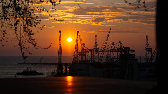 Golden sunset over the port cranes in Odesa, Ukraine