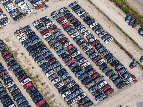 Aerial view of Cape Fear Pick N Pull featuring rows of salvaged vehicles parked in an organized lot with gravel paths under a clear sky in Wilmington, North Carolina, United States.