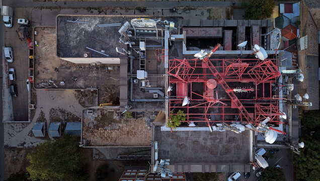 Aerial view of the Main Post Office rooftop in Pancevo, featuring red metal communication towers, satellite dishes, and technical equipment, Pancevo, Serbia.