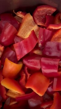 Cooking fresh red bell peppers in simmering tomato sauce - a healthy cooking video for recipes and cooking content