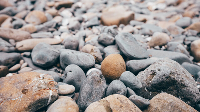 Smooth multicolored pebbles creating an abstract natural texture