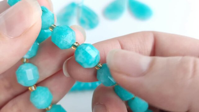 Vibrant turquoise amazonite gemstone beads and matching polished teardrop pendants displayed on a clean white surface for jewelry making and craft design projects