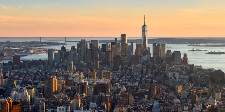 Panoramic elevated view of the Lower Manhattan skyline at sunset, the skyscrapers of the Financial District, the Hudson River and New York Harbor, New York City, USA