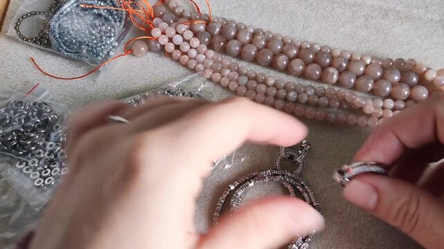 Detailed overview of premium jewelry making components showcasing polished metallic clasps, sparkling rhinestone rings, and smooth natural gemstone beads arranged for artisan design projects.