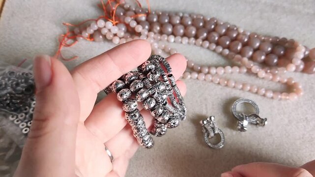 Detailed overview of premium jewelry making components showcasing polished metallic clasps, sparkling rhinestone rings, and smooth natural gemstone beads arranged for artisan design projects.