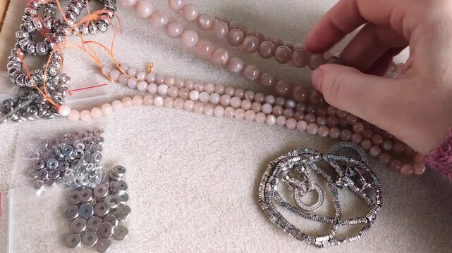 Detailed overview of premium jewelry making components showcasing polished metallic clasps, sparkling rhinestone rings, and smooth natural gemstone beads arranged for artisan design projects.