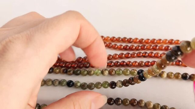 Exquisite natural garnet and multi-colored gemstone bead strands featuring smooth round polished surfaces for professional jewelry crafting and custom artisan accessories