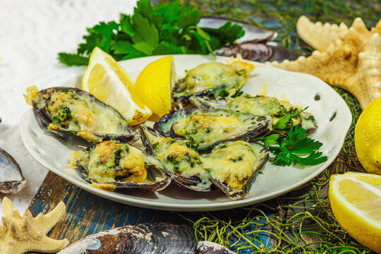 Baked mussels with cheese, herbs, and lemon on a plate, white-sand beach background