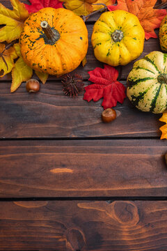 Autumn background with pumpkins and colorful leaves
