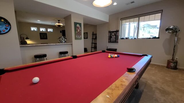 Basement billiards room with red felt pool table