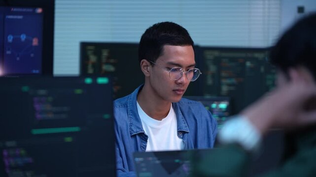 Focused programmer working late at night on innovative technology solutions in a modern office environment