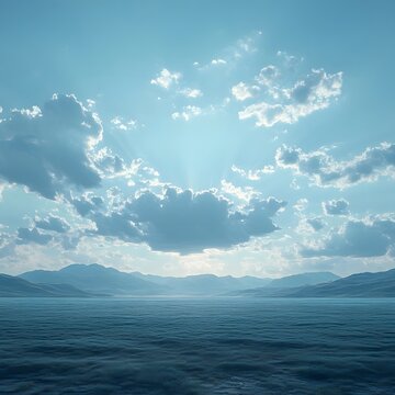 Serene ocean landscape with dramatic sunrays breaking through clouds over distant mountains.