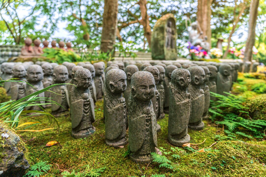 Stone Jizo statues in rows at Hase-dera temple in Kamakura Japan