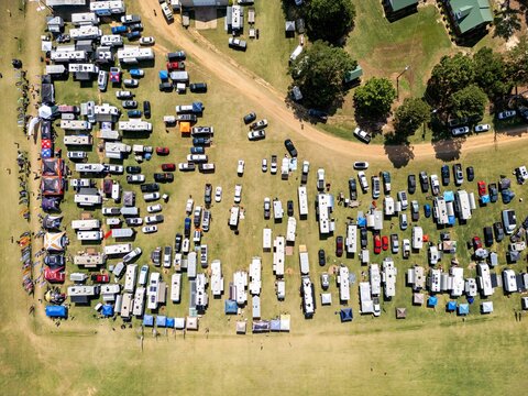 Aerial view of Hodges Field during the Bad Apples PPG fly-in event with numerous RVs and campers parked in a large grassy field, Andersonville, Georgia, United States.