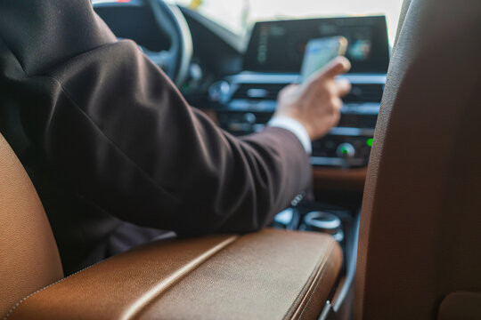 Blurred premium ride sharing transfer with driver using smartphone navigation from passenger seat view