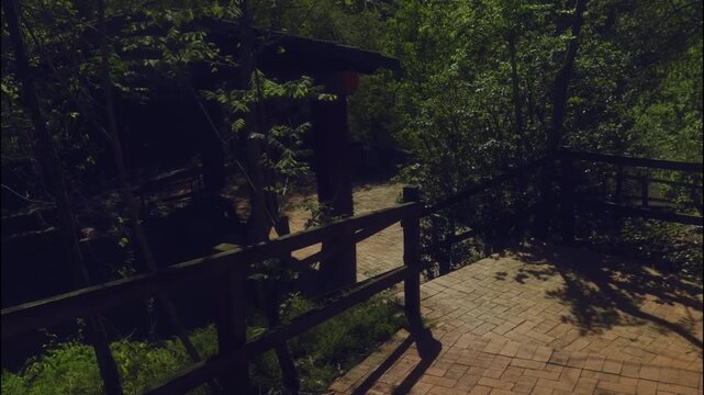 Modern brick pathway with wooden railing in lush garden