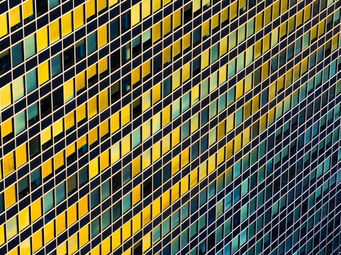 Aerial view of the geometric facade of a modern building in the EUR district featuring a grid of windows reflecting golden light Rome, Lazio, Italy.