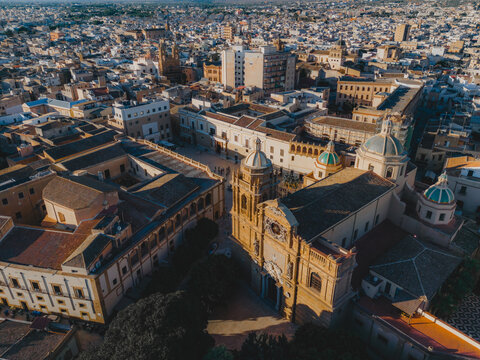 Aerial view of the Cathedral of the Holy Savior with its distinctive domes surrounded by historic rooftops and urban architecture in Mazara del Vallo, Sicily, Italy.