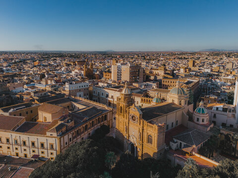 Aerial view of the Cathedral of the Holy Savior surrounded by historic stone rooftops and narrow streets in Mazara del Vallo, Sicily, Italy.