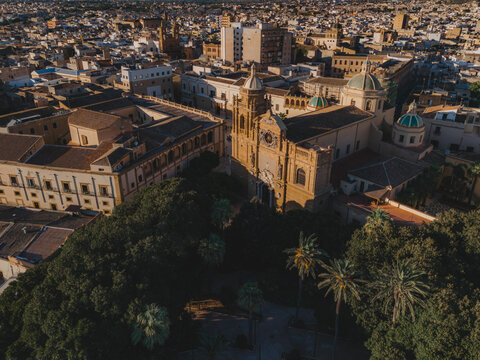 Aerial view of the Cathedral of the Holy Savior surrounded by historic buildings and lush trees in Mazara del Vallo, Sicily, Italy.
