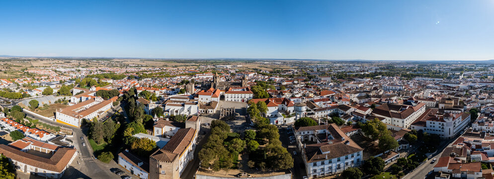 Aerial view of the historic center of Evora, featuring the Roman Temple and Cathedral surrounded by white-washed buildings and terracotta rooftops in Evora, Distrito de Evora, Portugal.