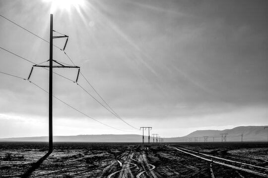 Power Line Poles In Gobustan Desert Landscape With Mountains
