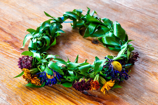 Fresh Flower And Leaf Wreath On Wooden Surface