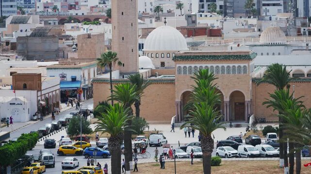 Aerial view of the iconic Bourguiba Mosque with its tall minaret amidst the bustling city of Monastir, Tunisia