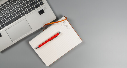 Workspace with laptop and notebook for planning tasks © mykhailo