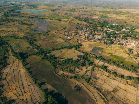 Aerial view of agricultural fields and a small village in the rural landscape Morondava, Menabe, Madagascar.