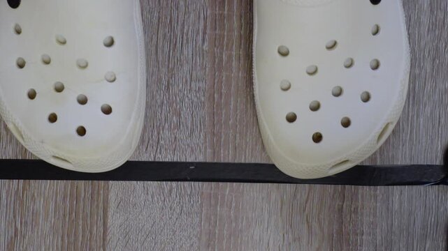 Tape marks placement. Floor marking with black tape for scene setup accuracy. Applying black tape crosses on flooring to ensure exact performer and camera positioning