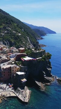 Picturesque coastal village in Cinque Terre with cliffside homes and sea views, aerial view