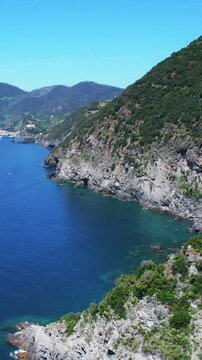 Aerial breathtaking view of the coastline in Cinque Terre, Italy, with azure blue waters, lush greenery on the cliffs