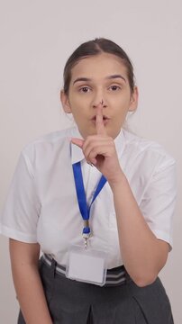 Vertical Shot of Indian Schoolgirl Looking and Shushing in Camera