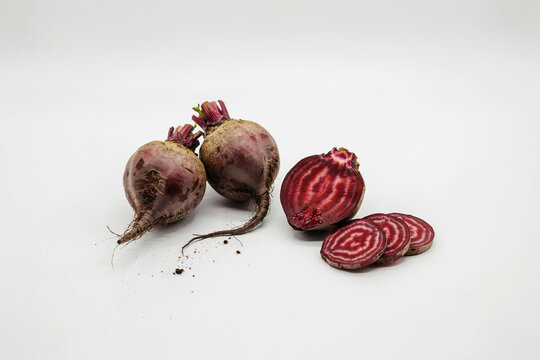Fresh whole and sliced red beetroots on a table